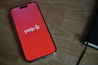 A cell phone sitting on top of a wooden table